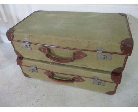 Two vintage canvas and leather suitcases, one with Broad Arrow marks to inside