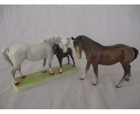 A Beswick Mare and Foal on base: Beswick grey mare with bay foal on ceramic grass base model 1811 (A/F) along with a Beswick 