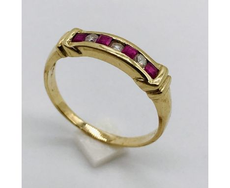 A diamond and ruby seven stone ring set in 9ct gold