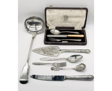 A hallmarked silver Christening set along with a small quantity of silver plated cutlery including a large ladle