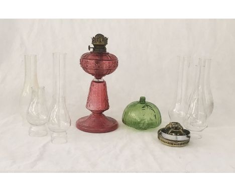 An antique glass oil lamp, green shade and various other accoutrements 