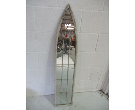 A Gothic arched mirror with wire decoration