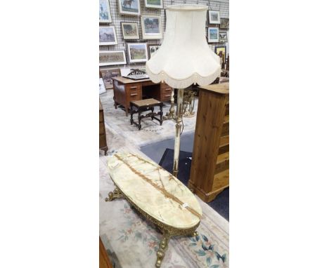 White onyx standard lamp with brass fittings and a matching oval coffee table 