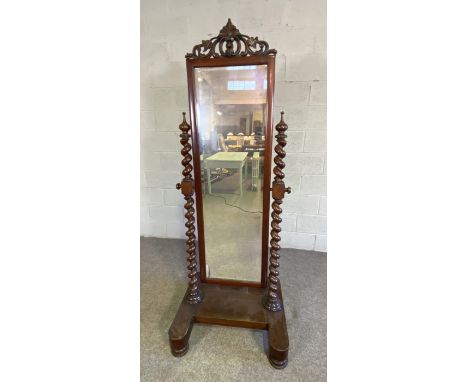 A Victorian mahogany cheval mirror, mid 19th century, the tall rectangular bevelled plate in a frame with fretwork surmount a