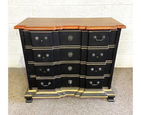 An Italian style breakfront commode, with a polished shaped top over four drawers, painted and gilt, 81cm high, 91cm wide