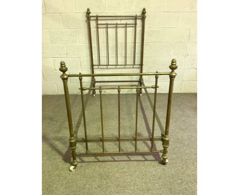 A late Victorian single brass bed frame, with turned finial and iron supports, 90cm wide, 188cm long