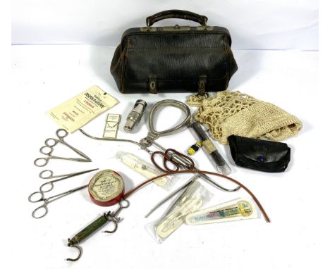 A vintage leather Doctor or Midwife&rsquo;s bag, mid 20th century, containing an assortment of surgical tools, mainly for mid