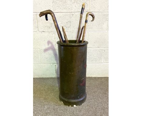 A vintage stoneware decorated chimney pot umbrella stand, painted with berries; also a group of canes, and a wicker carpet be