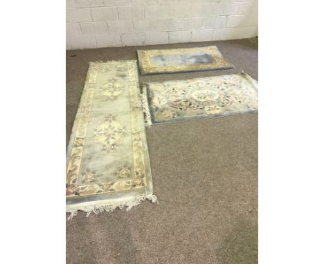 Four assorted rugs, including three modern French style rugs, with floral borders on light blue ground; and a Caucasian triba