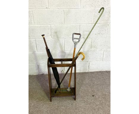 A group of items, including a long twist glass cane, 127cm long, a vintage umbrella with Cloissone handle, in a stick stand, 