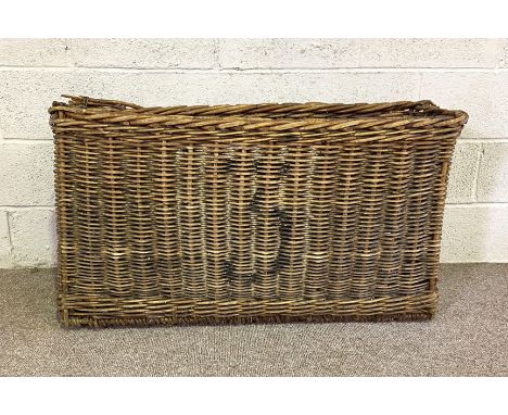 A large and narrow vintage wicker basket, 105cm wide and 60 cm high