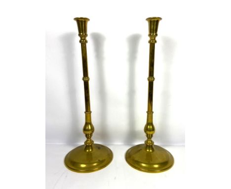 A pair of tall vintage brass candlesticks, each with a knopped baluster stem and spreading circular base, 52cm high