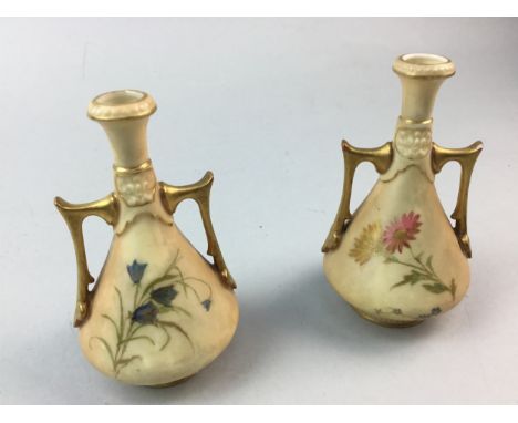 PAIR OF ROYAL WORCESTER TWIN HANDLED MINIATURE VASES, blush, with floral decoration and gilt detailing, 11cm high
