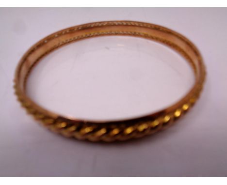 A 9ct gold circular bangle.  CONDITION REPORT: 16.1g