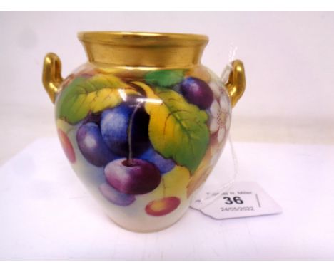 A Royal Worcester gilt-rimmed twin-handled vase, with hand painted Cherry decoration, signed by Kitty Blake, height 9 cm.