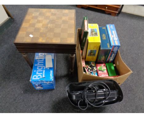 A box containing assorted board games, jigsaw, domino's, card games, together with a paper shredder, a bright light and a che