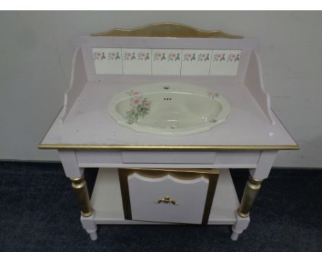 A painted and gilt washstand with ceramic sink