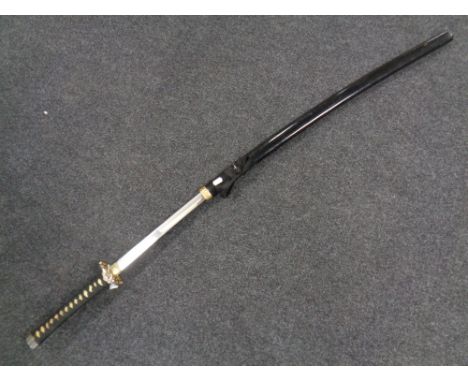 A reproduction Japanese katana in scabbard 