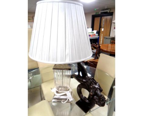 A contemporary metal and glass table lamp with shade together with a further contemporary figure, reclining female.