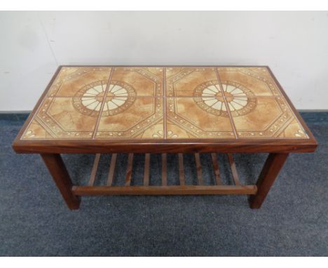 A rectangular teak tile topped coffee table 