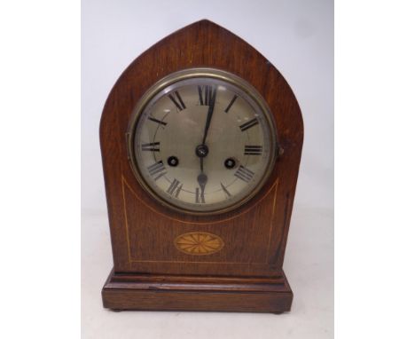 A late 19th century inlaid mahogany arch top eight day mantel clock with silvered dial 