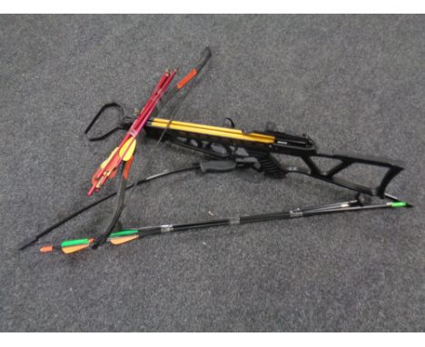 A crossbow with bolts together with an archery bow with arrows