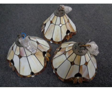 A set of three leaded glass light shades