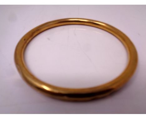 A 9ct gold circular bangle (dented) CONDITION REPORT: 11.8g