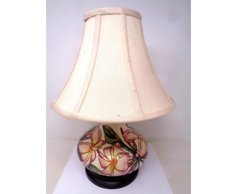 A Moorcroft Pink Magnolia bulbous table lamp with shade on wooden stand. Lamp base 18.5 cm 