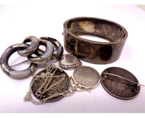 An antique silver bangle, a hardstone set silver brooch (a/f), a locket, a coin pendant and two similar brooches. (6)