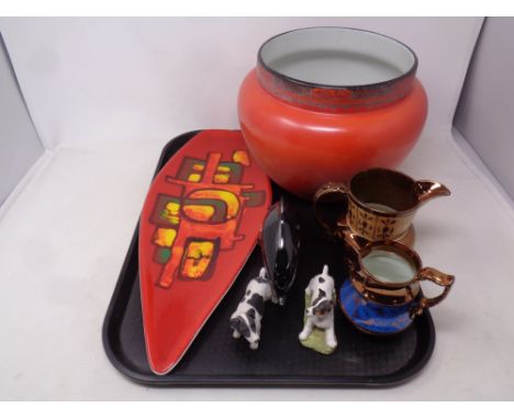 A tray containing assorted ceramics to include a shaped Poole plate, Poole dolphin, copper lustre jugs, Burleigh ware planter