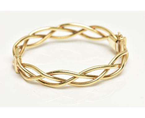 A 9CT GOLD HINGED BANGLE, openwork weaved bangle, fitted with a push piece clasp and two figure of eight safety clasps, hallm