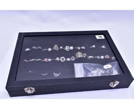 A RING DISPLAY BOX WITH RINGS, to include thirty-four white metal rings of various designs all stamped 925, one ring set with