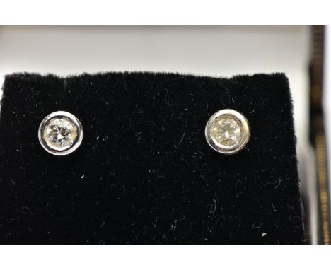 A PAIR OF DIAMOND STUD EARRINGS, each collet set with a round brilliant cut diamond, each approximately 0.10cts, total estima