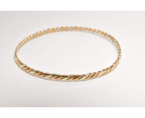 A BI-COLOUR TWIST BANGLE, alternating yellow and white metal bars, hallmarked 9ct Birmingham, approximate internal diameter 6