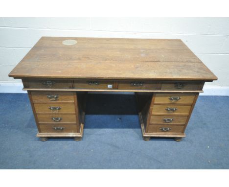 AN EARLY 20TH CENTURY OAK PEDESTAL DESK, with four frieze drawers, and four drawers to each pedestal, on triple bobbin legs, 