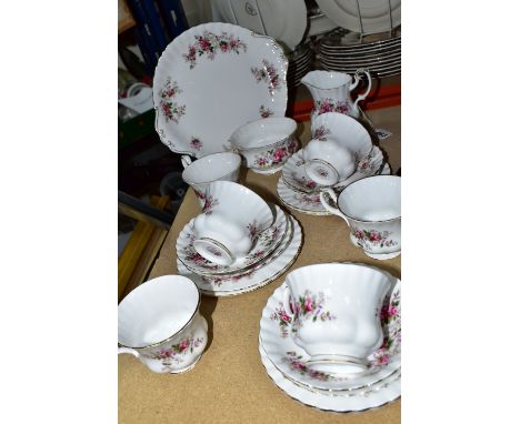 A TWENTY ONE PIECE ROYAL ALBERT LAVENDER ROSE TEA SET, comprising a cake plate, a cream jug, a sugar bowl, six tea plates, si