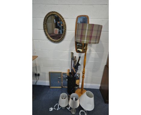 A SELECTION OF MIRRORS, to include foliate gilt wall mirror, a beech standard lamp, three table lamps, and a stick stand cont