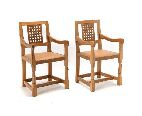 Workshop of Robert Mouseman Thompson (Kilburn): Two English Oak Lattice Back Arm Chairs, 2007, nail tan cow hide seats, on oc