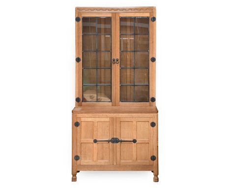 Workshop of Robert Mouseman Thompson (Kilburn): An English Oak Drinks' Display Cupboard, the glazed upper section with four g