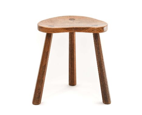 Robert Mouseman Thompson (1876-1955): An English Oak Cow Stool, the shaped 3cm thick top, on three octagonal legs, with carve