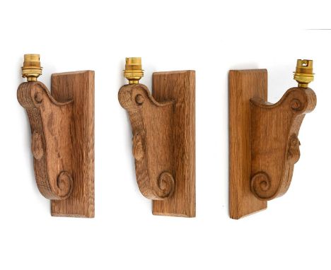 Workshop of Robert Mouseman Thompson (Kilburn): Three English Oak Single Wall Light Brackets, each with a rectangular mountin