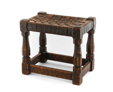 Robert Mouseman Thompson (1876-1955): An English Oak Stool, strap leather top, on four octagonal legs joined by stretchers, p