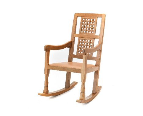 Workshop of Robert Mouseman Thompson (Kilburn): An English Oak Rocking Chair, with two lattice panel backs, shaped arms and c