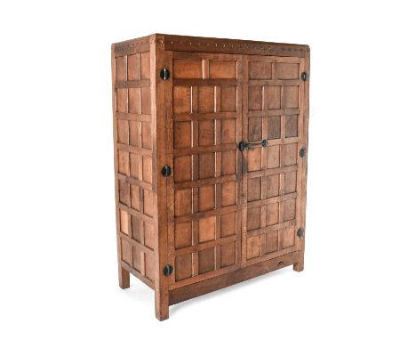 Robert Mouseman Thompson (1876-1955): An English Oak Panelled Double Wardrobe, circa 1940s, with half penny moulding, wrought