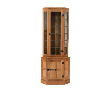 Workshop of Robert Mouseman Thompson (Kilburn): An English Oak Corner Display Cupboard, the upper section with leaded glazed 