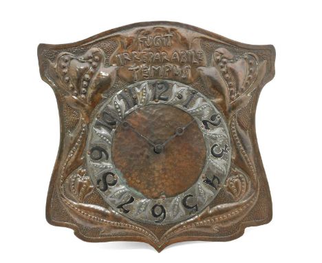 An Arts &amp; Crafts Copper Wall Clock, attributed to John Pearson, embossed with FUGIT IRREPARABILE TEMPUS and stylised flow