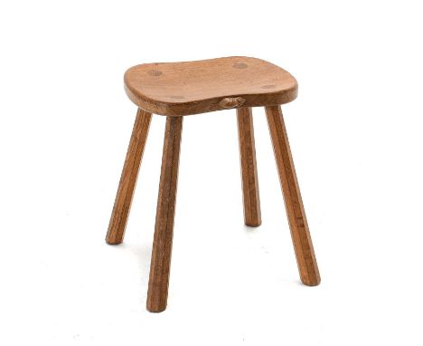 Workshop of Robert Mouseman Thompson (Kilburn): An English Oak Cow Stool, with shaped seat, on four octagonal legs, with carv