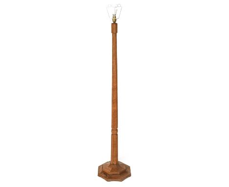 Workshop of Robert Mouseman Thompson (Kilburn): An English Oak Standard Lamp, octagonal column and base, with carved mouse tr