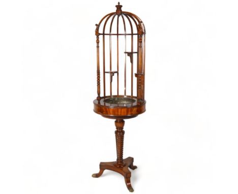 A mahogany floor-standing planter, with carved and spindled upper part, copper plant well, raised on spiral turned column and